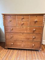 Front view of pine dresser showing all seven drawers and knobs