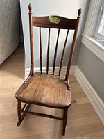 Front view of wood spindle-back rocking chair