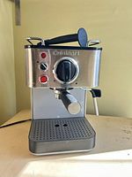 Front view of espresso machine showing controls, steam wand and drip tray