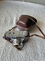 Top view of Kodak Retina Automatic I camera in leather case showing collapsible lens and controls