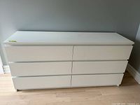Front view of white six-drawer dresser