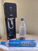 Front view of SodaStream carbonator with bottle and spare CO2 cylinder