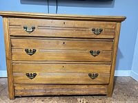 Front view of solid wood three-drawer dresser