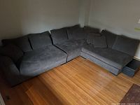 Overall view of gray sectional sofa in L configuration