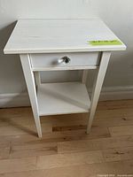Front view nightstand showing drawer knob and shelf