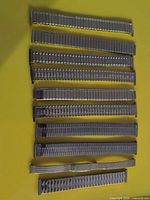 Eleven metal watch bands laid horizontally