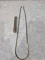 Necklace and bracelet laid flat on tabletop