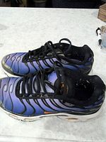 Side view of both sneakers showing uppers, laces, midsoles