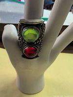 Front view showing green and red glass cabochons on ring