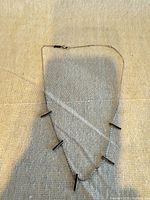 Full view of necklace showing bar stations and chain