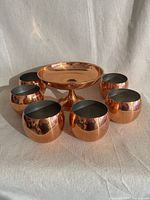 Full set: pedestal bowl centered with six cups surrounding