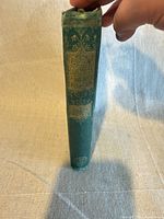 Spine view showing green cloth cover and gilt title