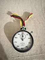 Front view of Meylan No. 400 stopwatch showing dial, bezel, ribbon