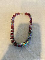 Full view of beaded necklace laid flat showing beads and clasp