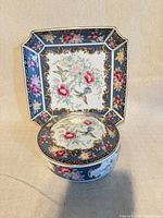 Round lidded box placed on matching tray showing full design