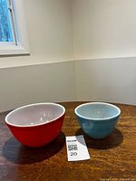 Orange and blue Pyrex bowls side by side rim up