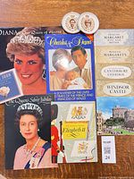 Assorted royal family books, two small commemorative dishes, ticket stub indicating lot