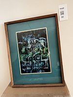 Framed abstract painting showing full view with teal mat and wood frame