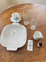 Group shot of all seven pieces: casserole with lid, two glasses, Dansk mug, creamer with saucer, bird figurine