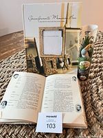 All three items displayed: open baby naming book, sealed Grandparents’ Memories Box, packaged stork plant watcher