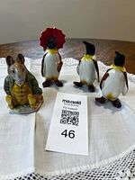 Group shot of all four figurines on cloth