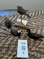 Group shot of all four painted cast bird figurines