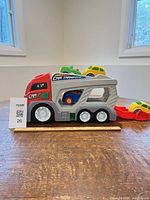 Side view of plastic car transporter with four cars loaded