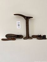 cobbler stand with five shoe forms displayed