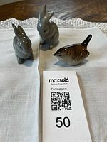 Front view of all three figurines on cloth