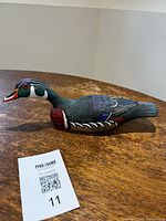 Full view of carved wood duck on table