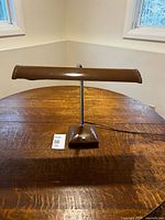 Front view of brown desk lamp on table
