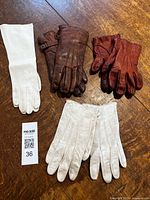 All four glove pairs displayed on table