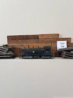 Locomotive 622 centred with stacks of straight and curved track pieces