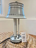 Full view of lamp showing shade, supports, cord, size tag
