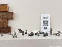 All fifteen pewter miniatures lined up on mantle