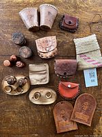 Entire lot overview showing tea set, leather pouches, leather cups, wooden shakers, discs, rings and bookmarks