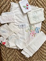 All eleven linens laid out showing main tablecloth, runner, tea towels and napkins