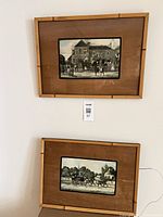 Both framed prints hung on wall