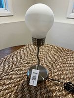 Full lamp view showing bulb shade, stem, base, and cord