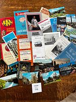 Spread of maps, brochures and postcards on table