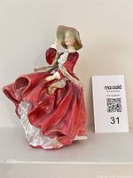Front view of Royal Doulton figurine in red dress