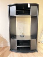 Full front view of black corner cabinet