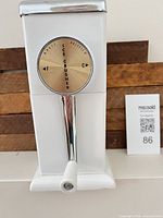 Front view of Magic Hostess ice crusher showing crank handle and dial