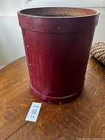 Full view of red wooden barrel on table