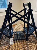 Full view of wooden doll swing showing A-frame and twin seats, lot tag visible