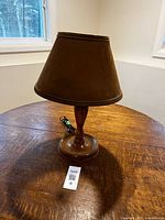 Full view of lamp on table showing base, shade, cord