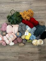 Group shot of all yarn skeins and balls on floor