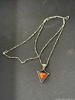 Full view of sterling chain and triangular amber pendant