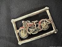 Front view of rectangular pot metal buckle with painted motorcycle design