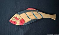 Front view of painted wooden salmon carving
